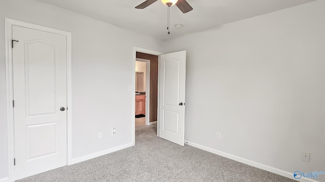 unfurnished bedroom with ceiling fan, baseboards, and light colored carpet