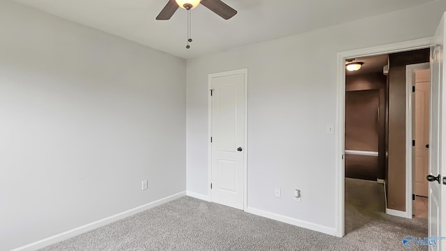 unfurnished bedroom with a ceiling fan, baseboards, and carpet flooring