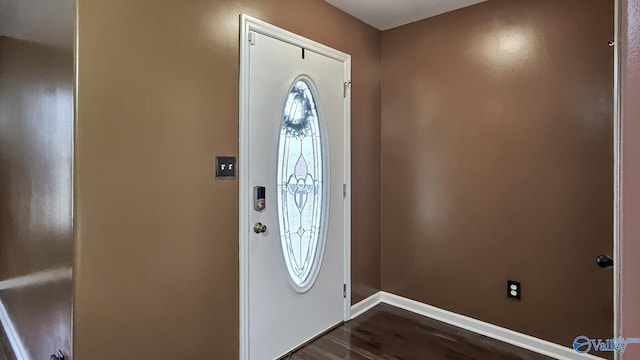 foyer entrance featuring dark wood-type flooring and baseboards