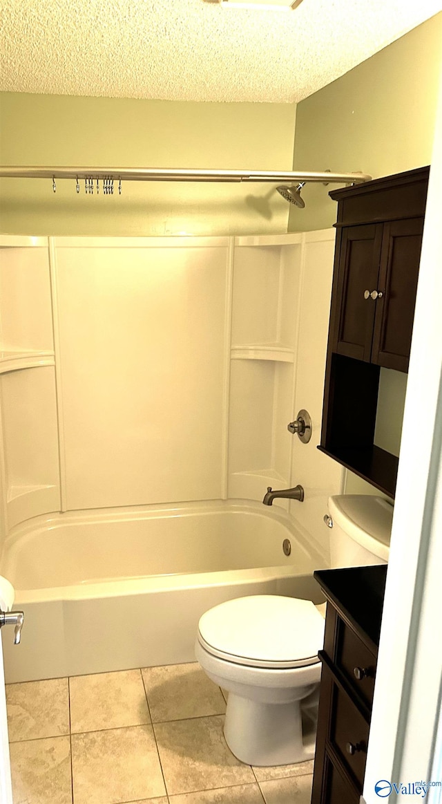 full bathroom featuring vanity, washtub / shower combination, tile patterned flooring, toilet, and a textured ceiling