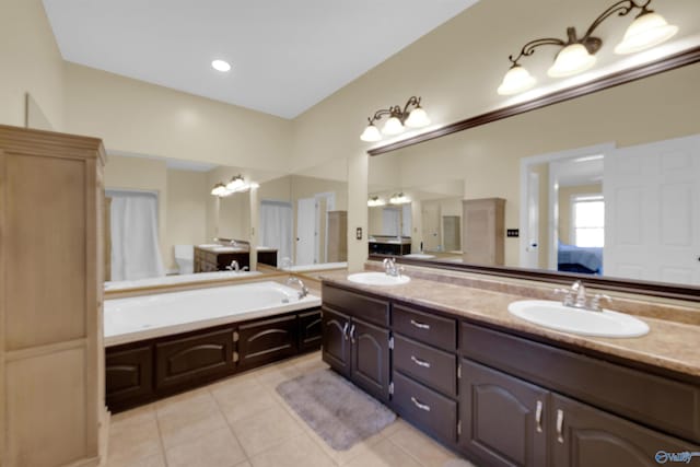 bathroom featuring tile patterned floors, a tub, and vanity
