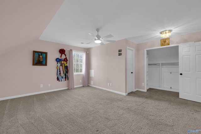 unfurnished bedroom with light carpet, lofted ceiling, ceiling fan, and a closet
