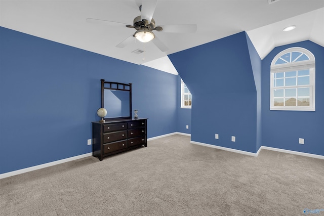 unfurnished bedroom featuring carpet, vaulted ceiling, and ceiling fan