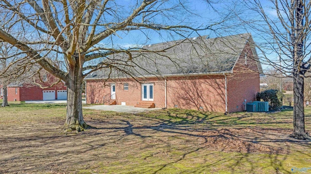 view of home's exterior with a garage and central air condition unit