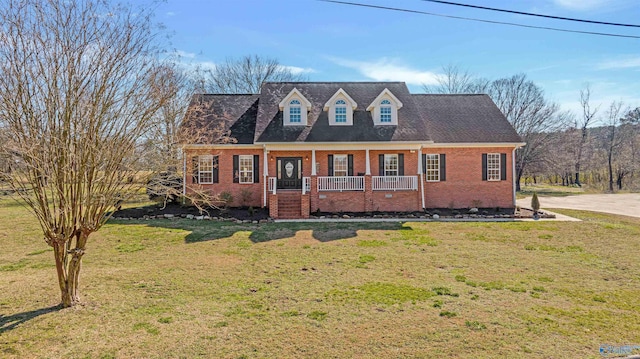 cape cod house featuring covered porch and a front lawn