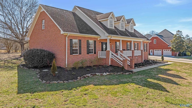 cape cod home featuring covered porch, a front yard, and a garage