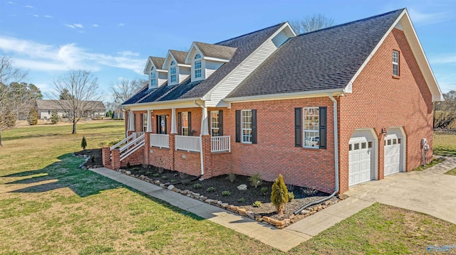 view of front of house featuring a garage, a front yard, and a porch