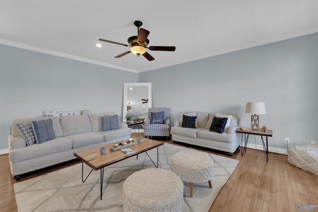 living room with ornamental molding, ceiling fan, and light hardwood / wood-style flooring