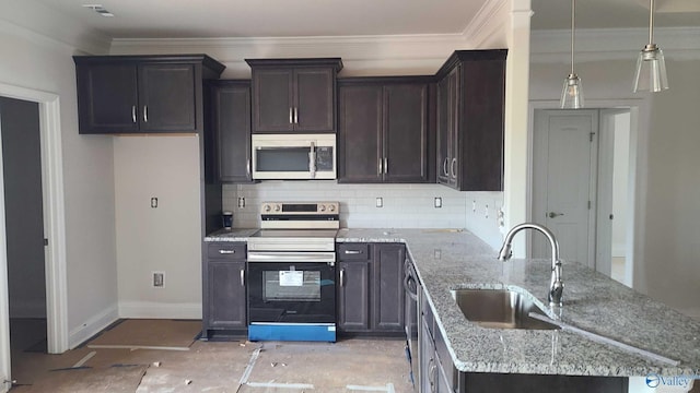 kitchen featuring light stone countertops, appliances with stainless steel finishes, sink, and decorative backsplash