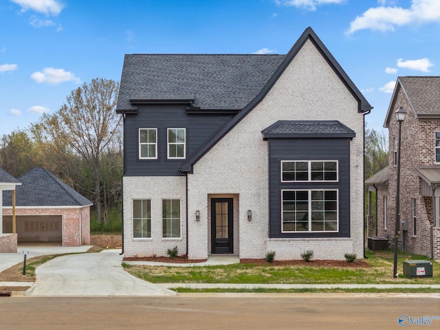 201 Fame Ave, Tuscumbia, AL 35674 - view of front facade with brick siding, a shingled roof, and central air condition unit