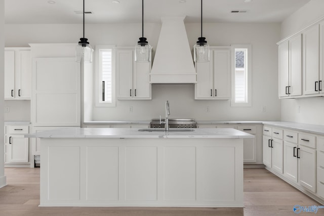 201 Fame Ave, Tuscumbia, AL 35674 - kitchen with a sink, premium range hood, white cabinetry, and a wealth of natural light