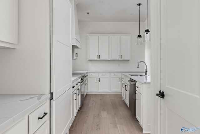 201 Fame Ave, Tuscumbia, AL 35674 - kitchen with a sink, stainless steel appliances, light wood-type flooring, and white cabinetry