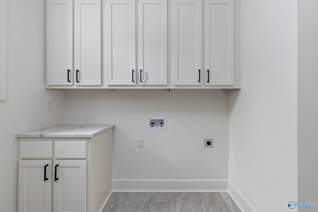 201 Fame Ave, Tuscumbia, AL 35674 - clothes washing area with baseboards, hookup for a washing machine, cabinet space, and hookup for an electric dryer
