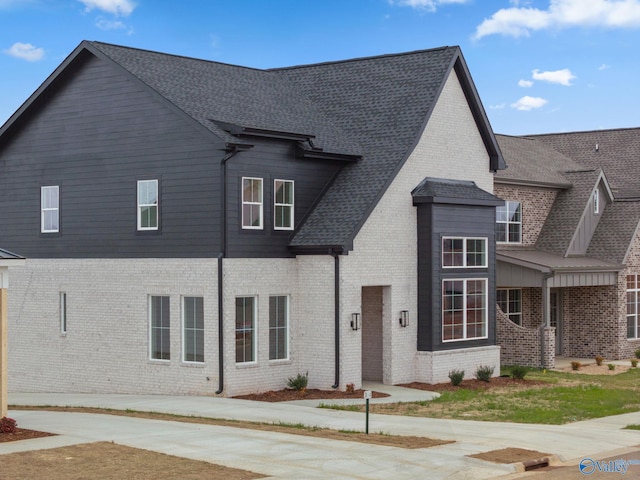 201 Fame Ave, Tuscumbia, AL 35674 - view of front of home featuring a shingled roof and brick siding