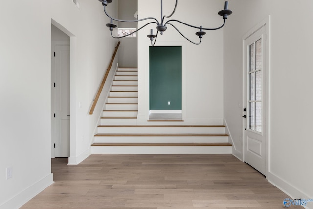 201 Fame Ave, Tuscumbia, AL 35674 - foyer featuring stairs, baseboards, a notable chandelier, and wood finished floors