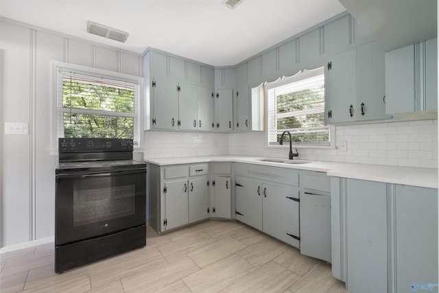 101 Arcade St, Gadsden, AL 35901 - kitchen with black electric range oven, backsplash, light countertops, and gray cabinets