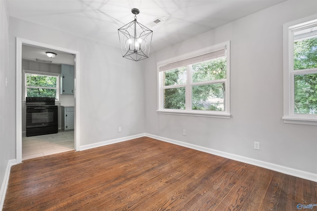 101 Arcade St, Gadsden, AL 35901 - spare room with healthy amount of natural light, a chandelier, and wood finished floors