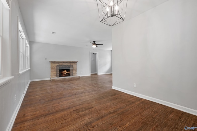 101 Arcade St, Gadsden, AL 35901 - unfurnished living room with ceiling fan, wood finished floors, a stone fireplace, and a chandelier