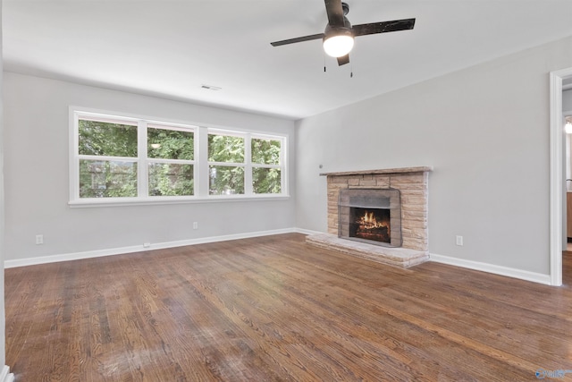 101 Arcade St, Gadsden, AL 35901 - unfurnished living room featuring a stone fireplace, a ceiling fan, and wood finished floors
