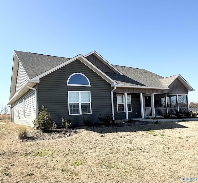 view of front of property with a porch and roof with shingles