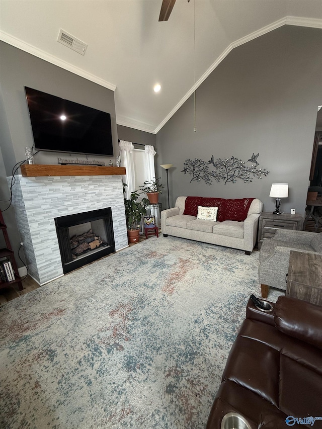 living room featuring vaulted ceiling, ornamental molding, a fireplace, and visible vents