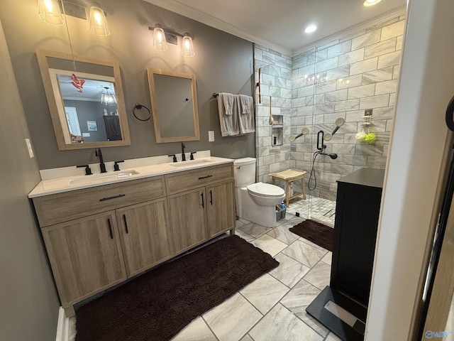 full bathroom with double vanity, toilet, marble finish floor, a shower stall, and a sink