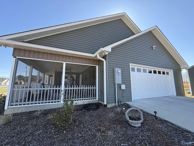 view of property exterior with driveway and a garage