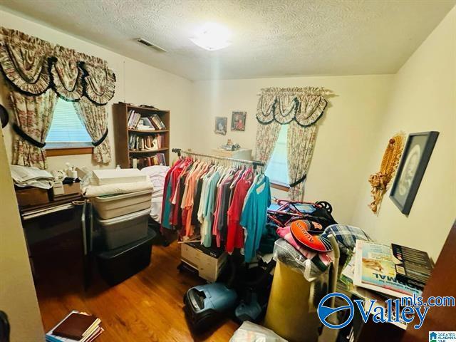 walk in closet featuring hardwood / wood-style floors