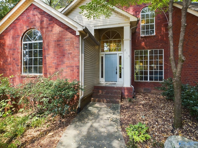 doorway to property with brick siding and crawl space