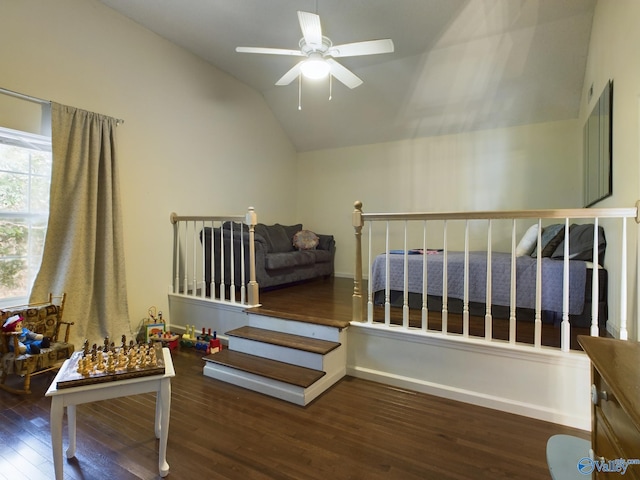 stairs with vaulted ceiling, hardwood / wood-style floors, and ceiling fan