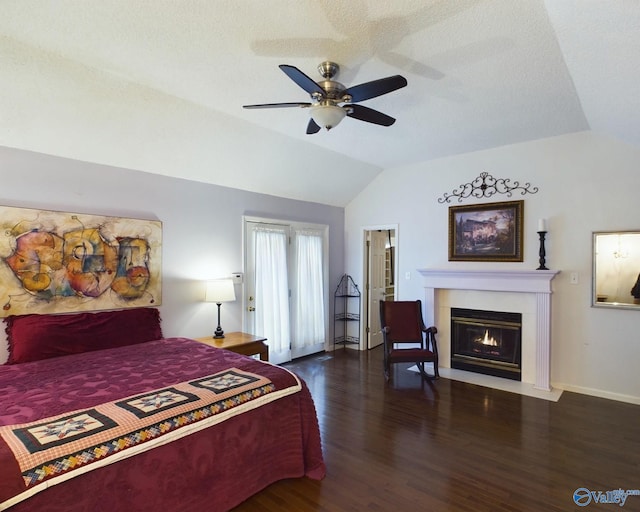 bedroom with lofted ceiling, ceiling fan, dark hardwood / wood-style floors, and a textured ceiling