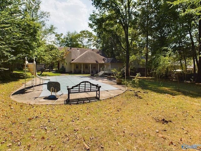 view of swimming pool with a lawn and a patio