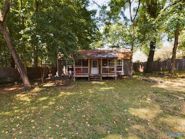 rear view of house featuring a yard