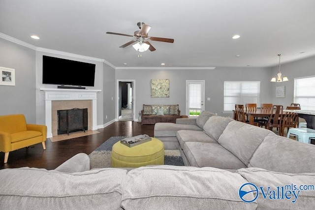 living room featuring dark wood-type flooring, ceiling fan, and ornamental molding