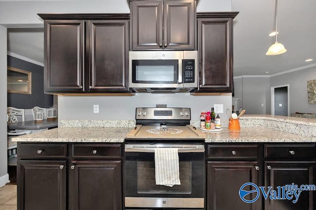 kitchen featuring appliances with stainless steel finishes, pendant lighting, dark brown cabinets, light stone countertops, and ornamental molding