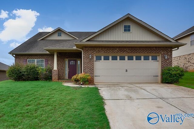 craftsman inspired home featuring a garage and a front yard