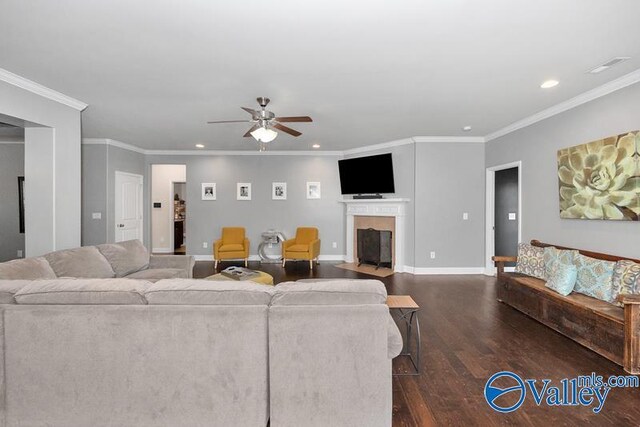 living room with dark wood-type flooring, ceiling fan, and ornamental molding