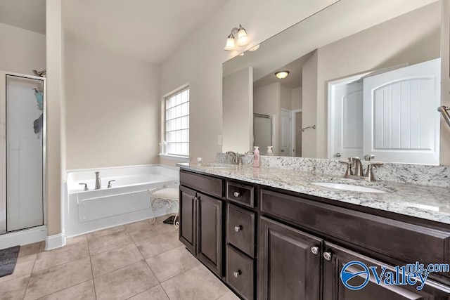 bathroom with double vanity, shower with separate bathtub, and tile patterned floors