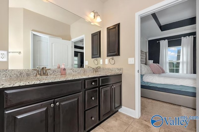 bathroom with tile patterned flooring and vanity