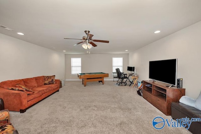 carpeted living room with ceiling fan and pool table