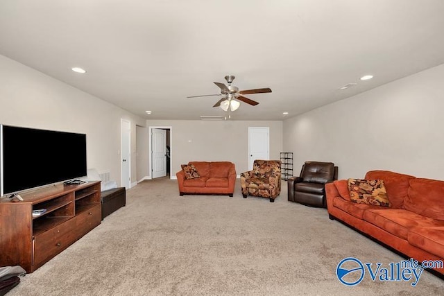 carpeted living room with ceiling fan