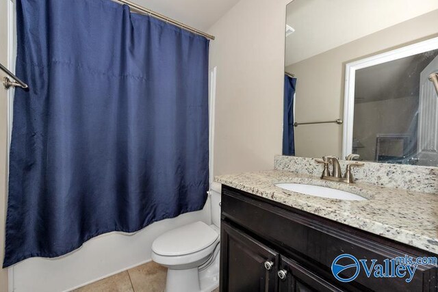 full bathroom with shower / tub combo, vanity, tile patterned flooring, and toilet