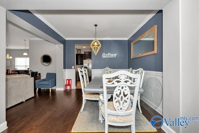 dining room featuring hardwood / wood-style flooring and crown molding