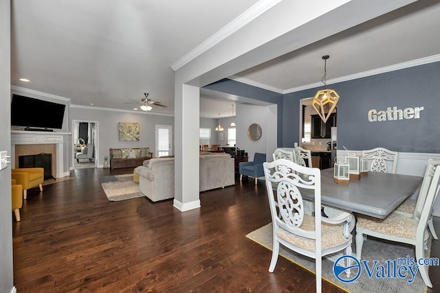 dining room with ornamental molding, ceiling fan, and dark hardwood / wood-style flooring