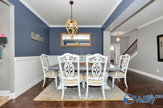 dining room with crown molding and dark wood-type flooring