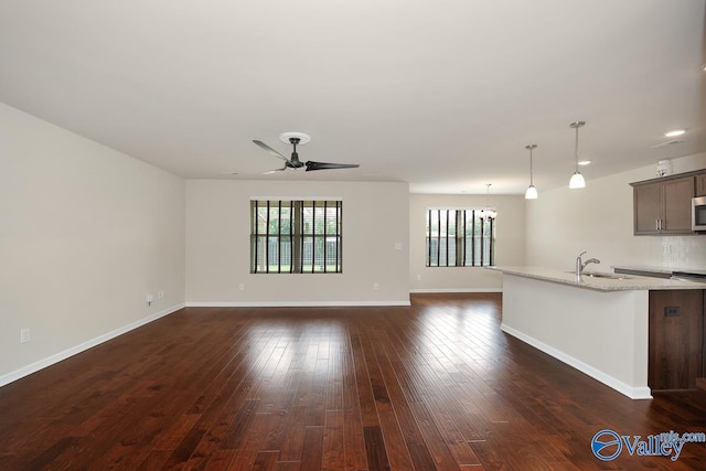 104 Summer Pointe Ln, Madison, AL 35757 - unfurnished living room with a sink, ceiling fan, dark wood-style flooring, and baseboards
