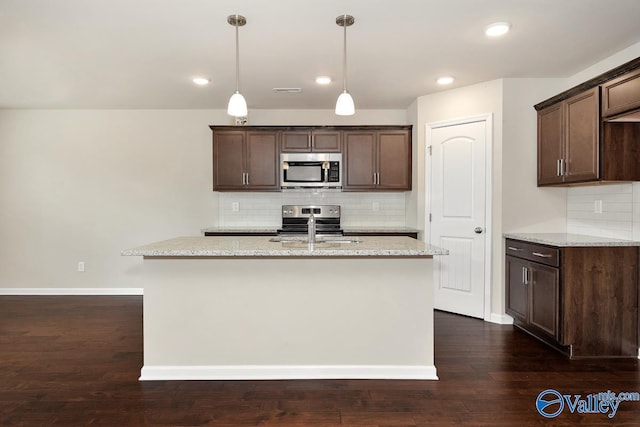104 Summer Pointe Ln, Madison, AL 35757 - kitchen featuring appliances with stainless steel finishes, decorative backsplash, dark brown cabinetry, light stone countertops, and recessed lighting