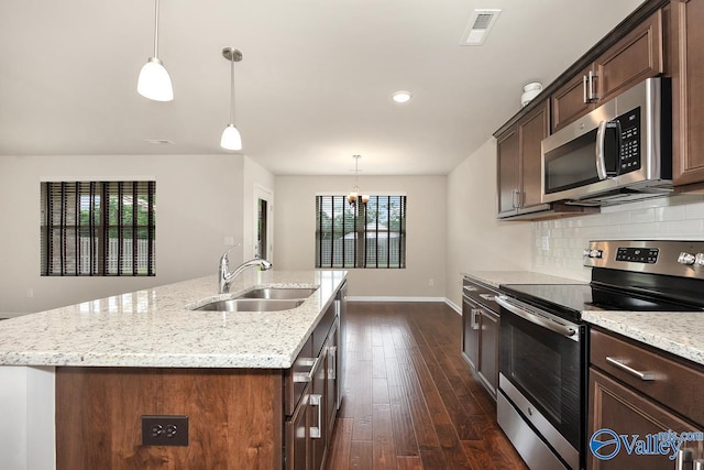 104 Summer Pointe Ln, Madison, AL 35757 - kitchen with appliances with stainless steel finishes, a sink, an island with sink, baseboards, and dark wood-style flooring