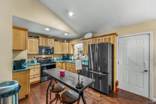 kitchen featuring dark hardwood / wood-style floors, lofted ceiling, light brown cabinetry, stainless steel appliances, and sink