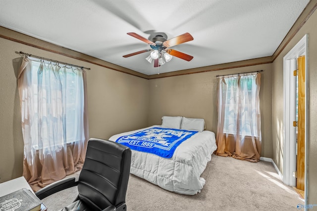 bedroom featuring crown molding, ceiling fan, and carpet floors